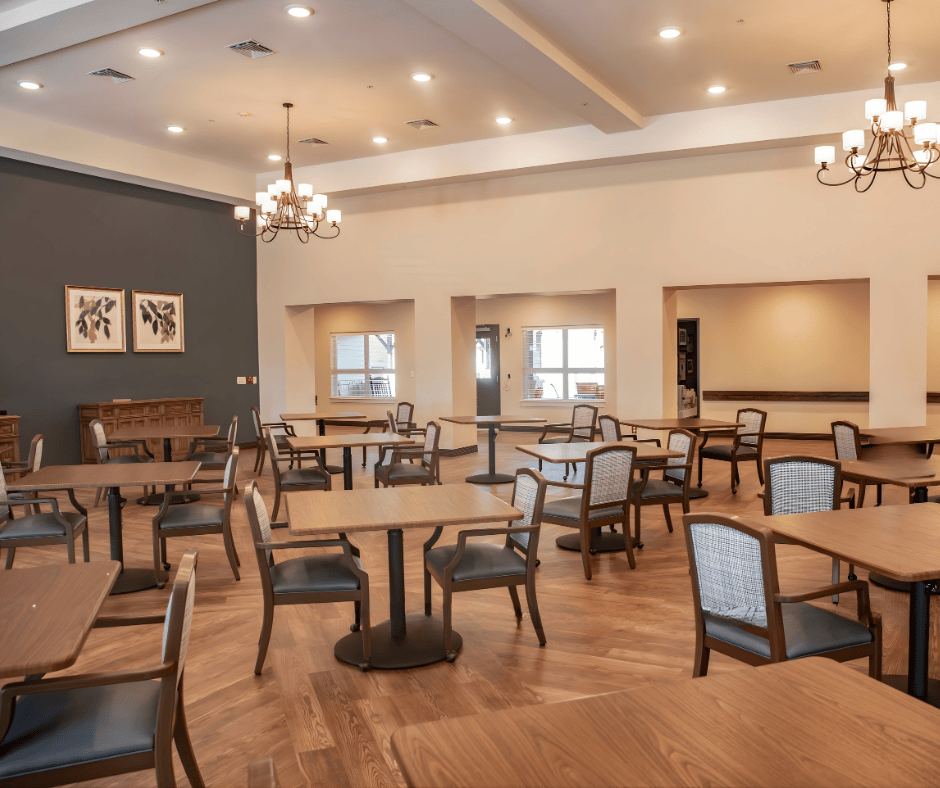 Caregiver helping senior people during lunch